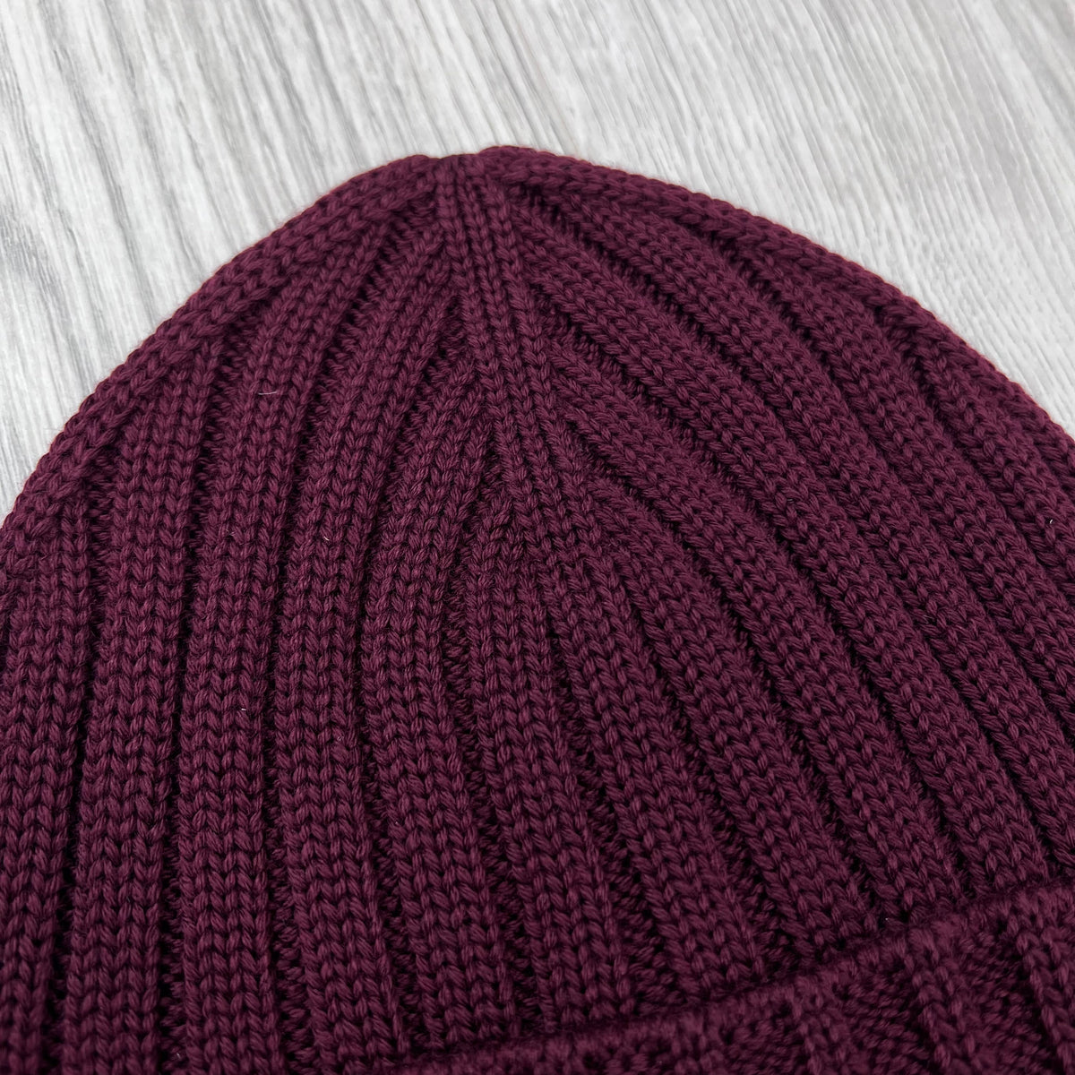 Close up view of the rib stitch on the CP Company Merino Wool Patch Beanie in Andorra.
