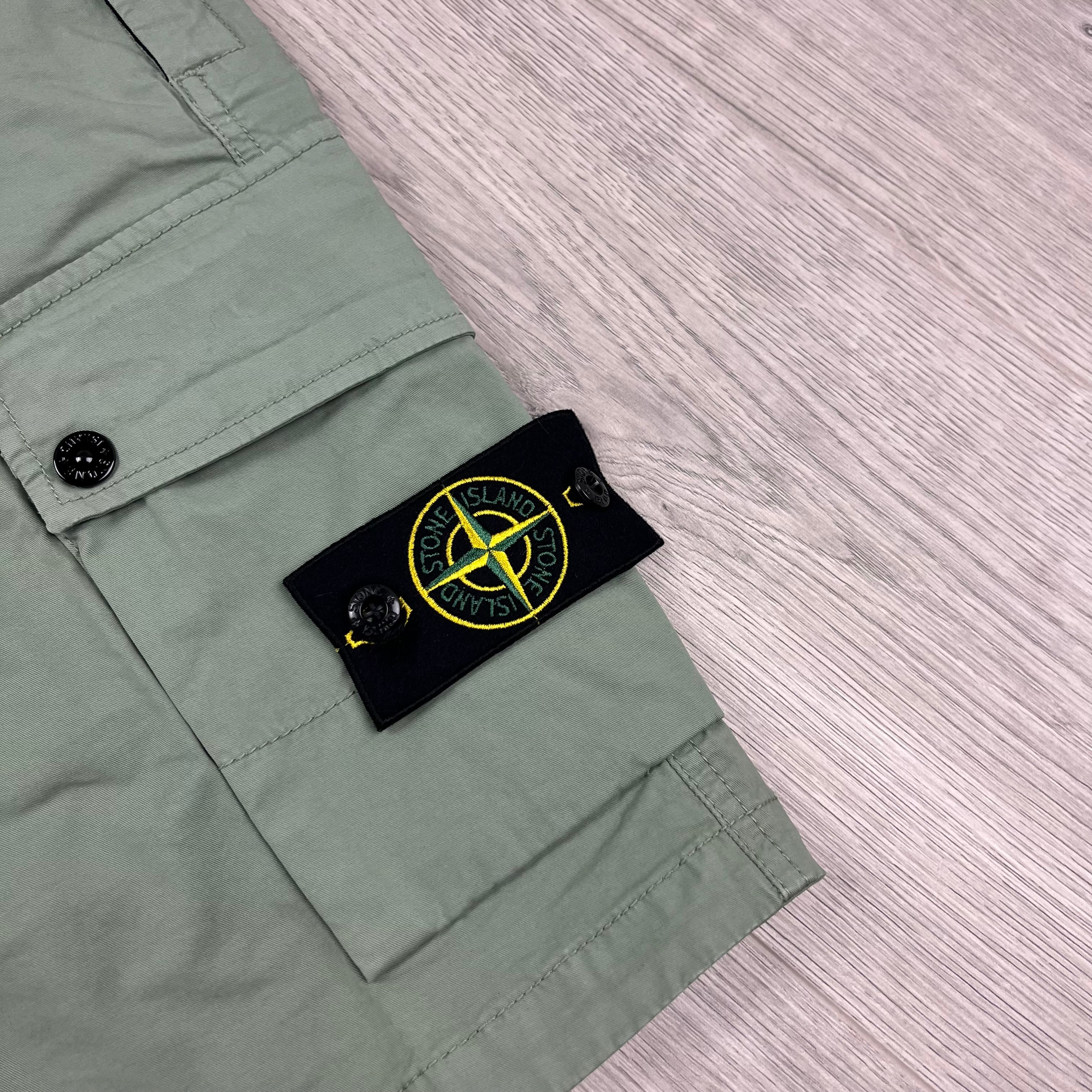 Stone Island Bermuda Cargo Shorts in Sage Green. On sale at Open Attire.