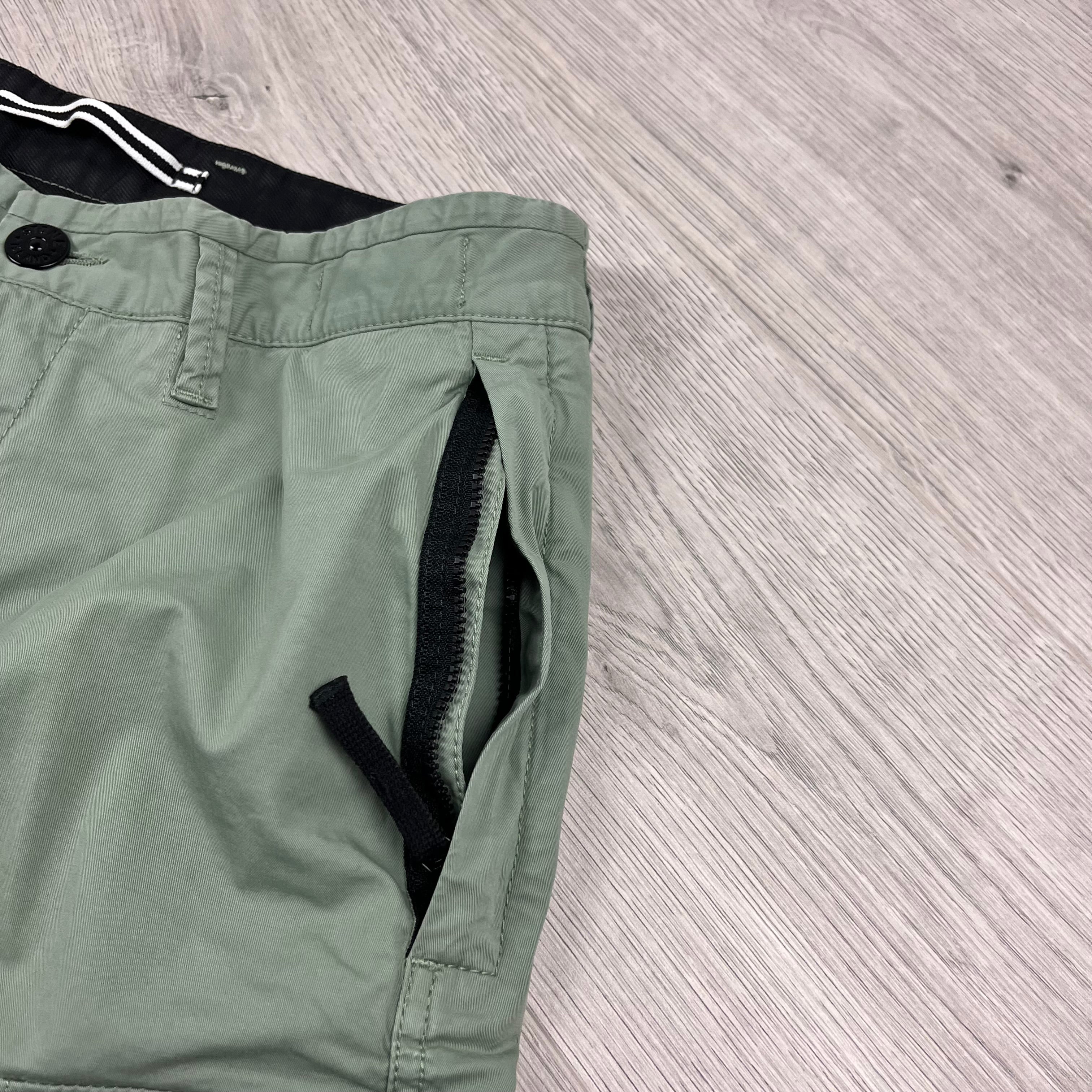 Stone Island Bermuda Cargo Shorts in Sage Green. On sale at Open Attire.