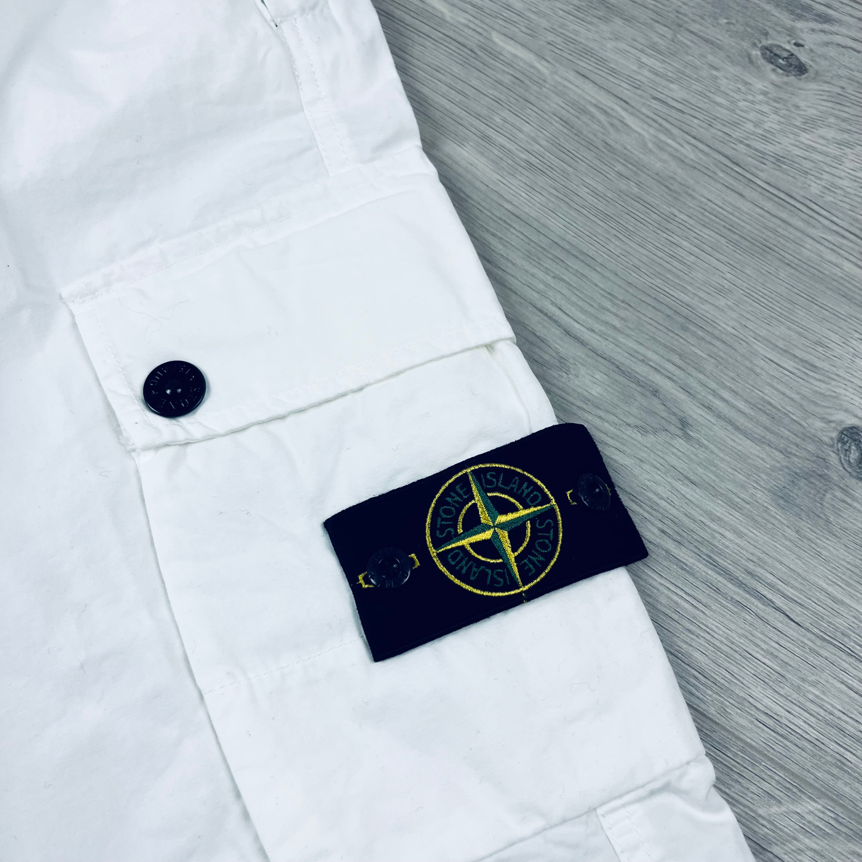 Stone Island 'OLD' treatment cargo trousers in White. On sale at Open Attire.