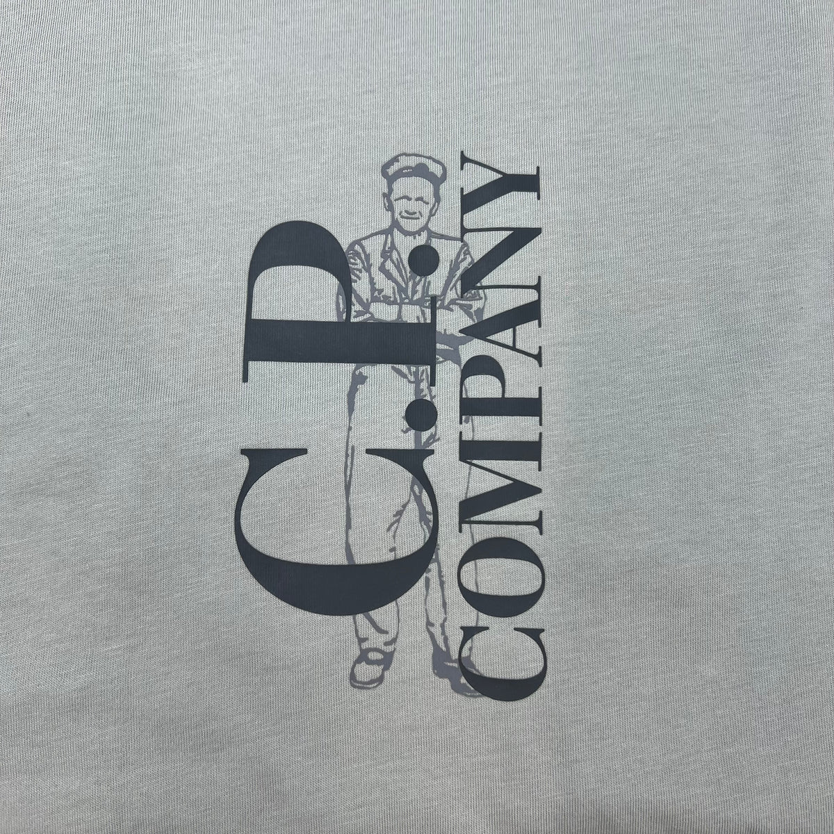Close up view of the printed logo on the CP Company 30/1 Sailor T-Shirt in Flint Grey. 