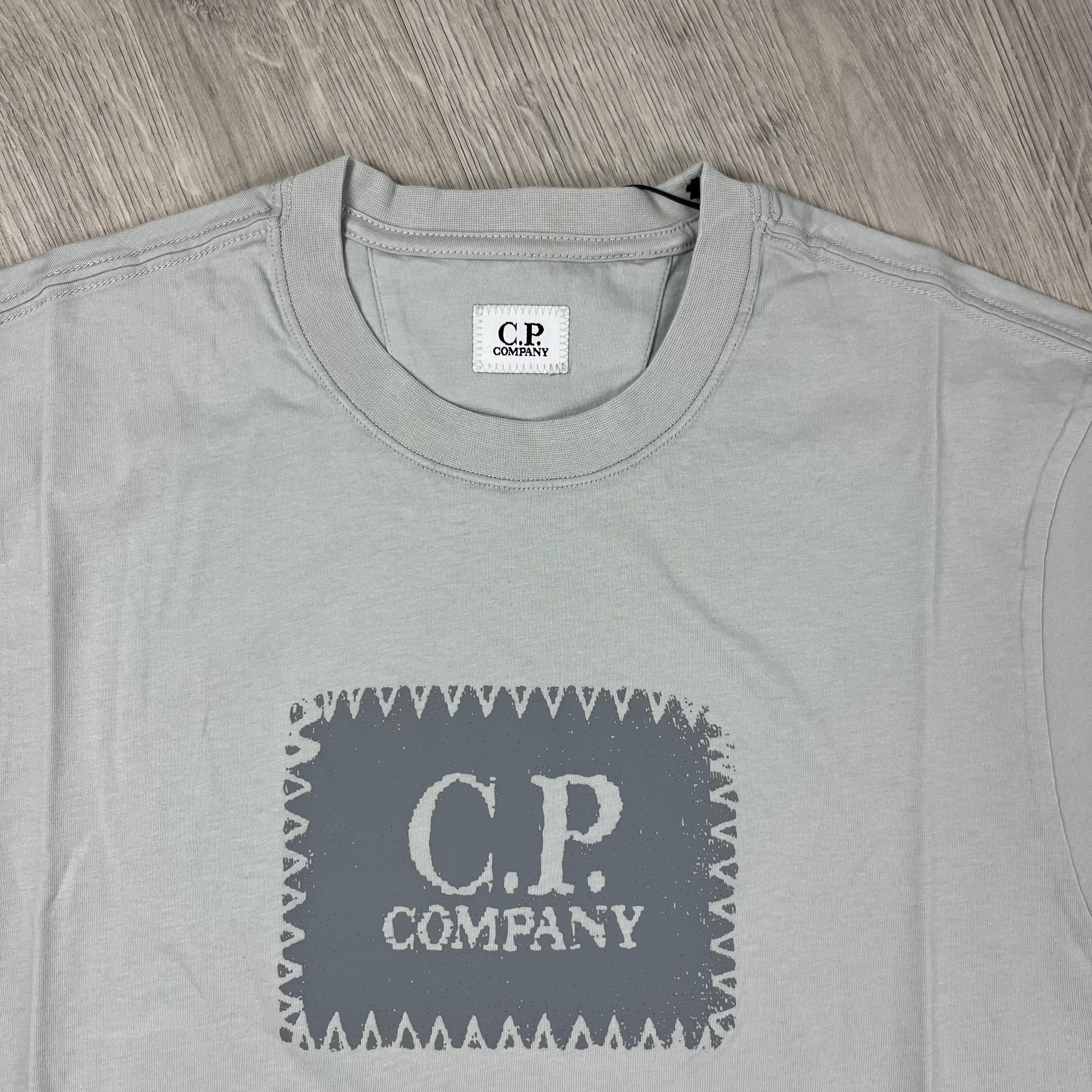 CP Company 30/1 Stamp Logo T-Shirt in Blue Fox. On sale at Open Attire.