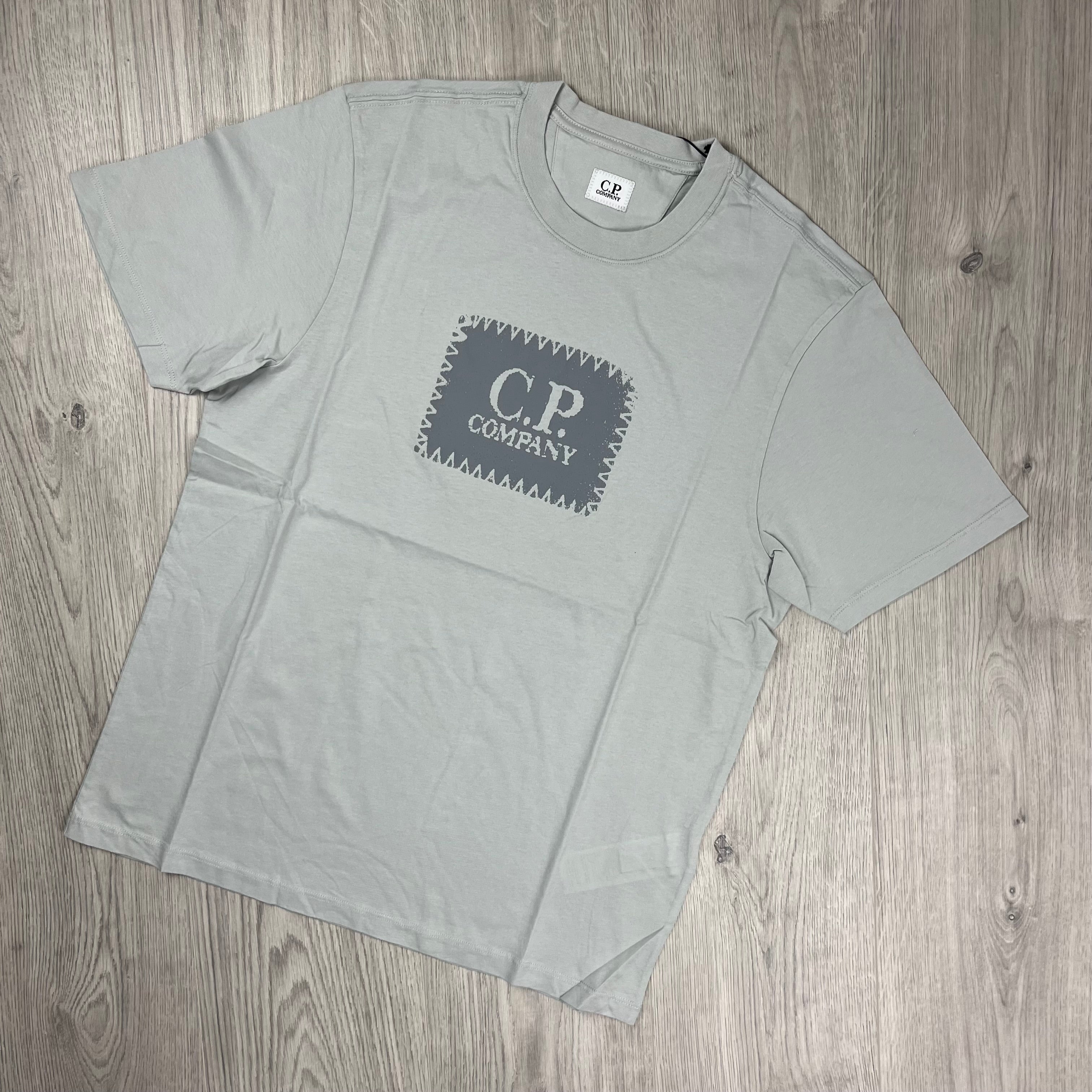 CP Company 30/1 Stamp Logo T-Shirt in Blue Fox. On sale at Open Attire.