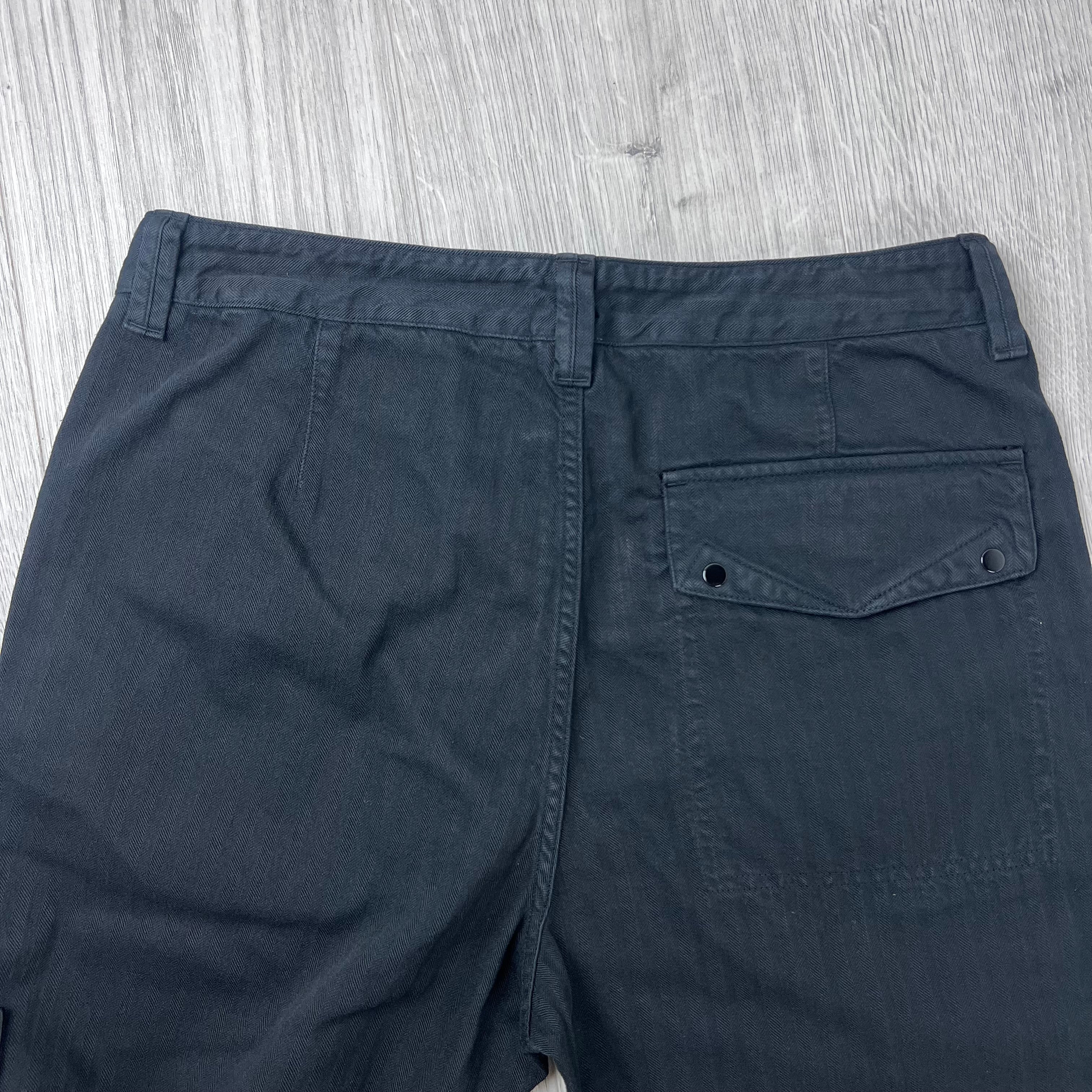 Rear view of the waistband and back patch pocket on the Stone Island Cotton Herringbone Chino Trousers in Black.