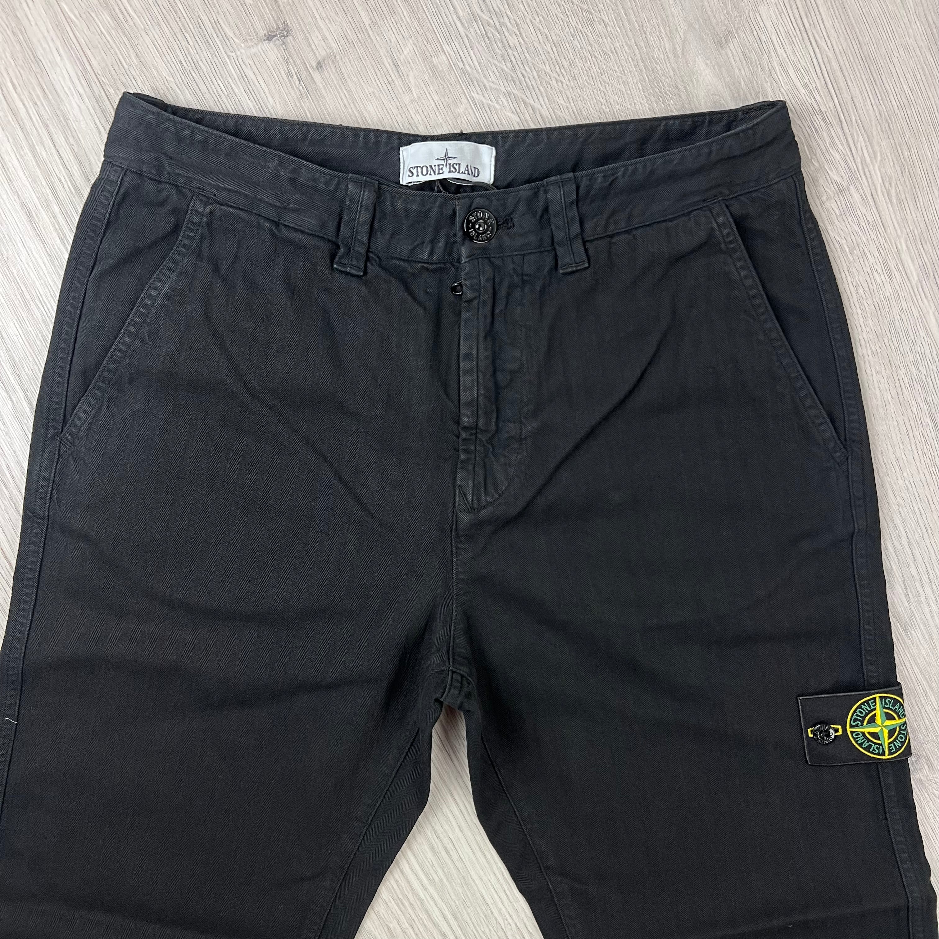 Front view of the waist closure on the Stone Island Cotton Herringbone Chino Trousers in Black.