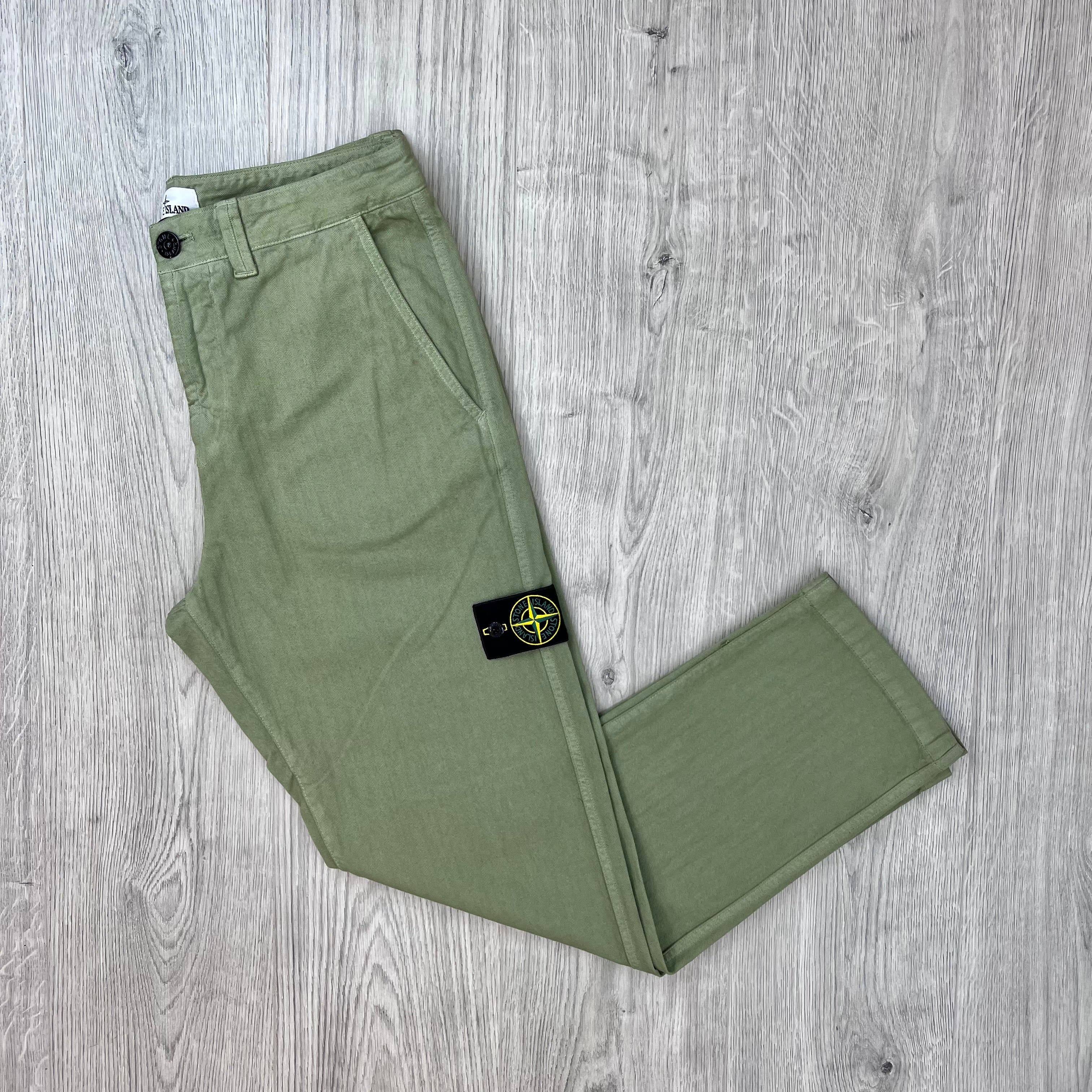 Front view of the Stone Island Cotton Herringbone Chino Trousers in Laurel Green.
