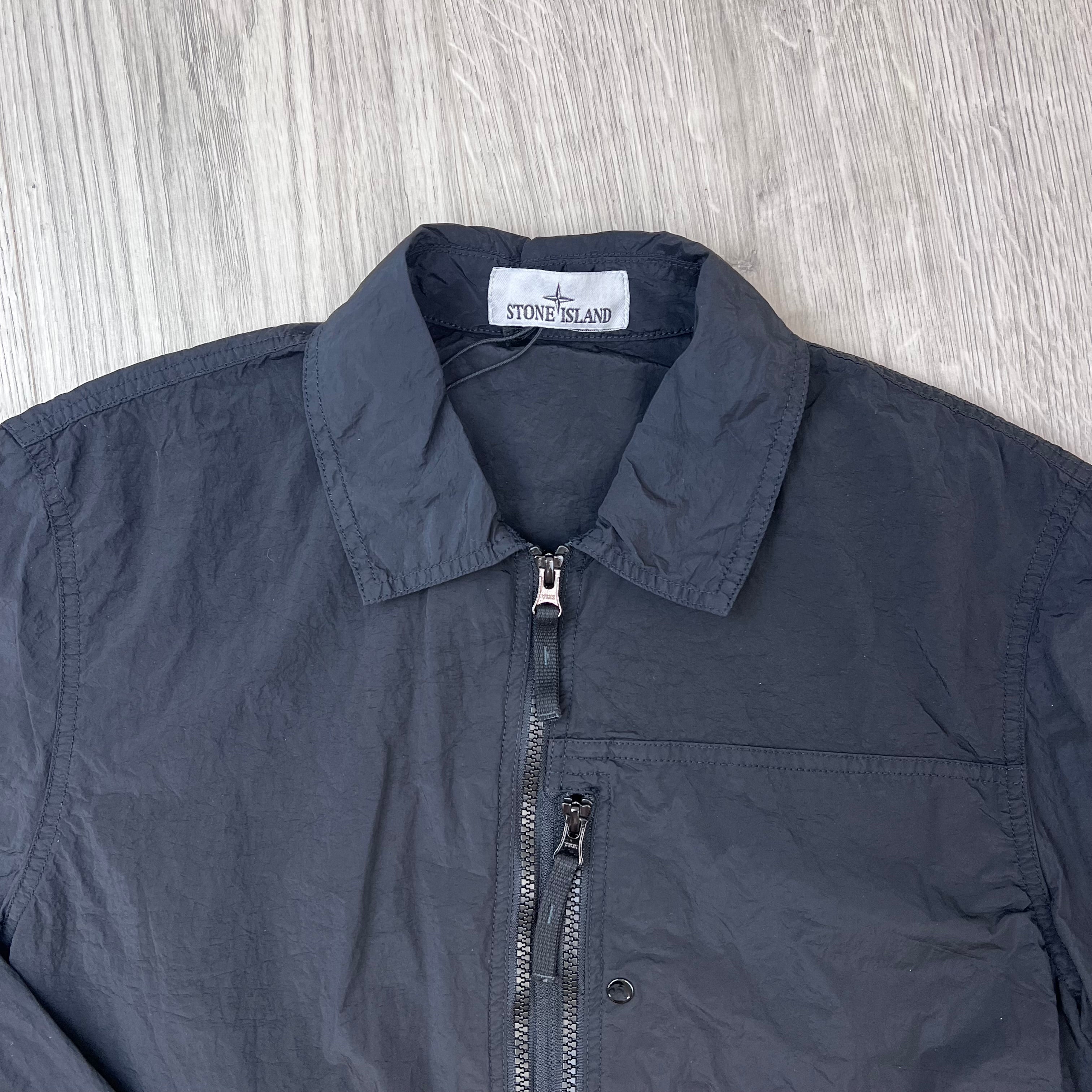 A close up view of the classic collar and neck label on a Stone Island Nylon Metal Overshirt in Black.