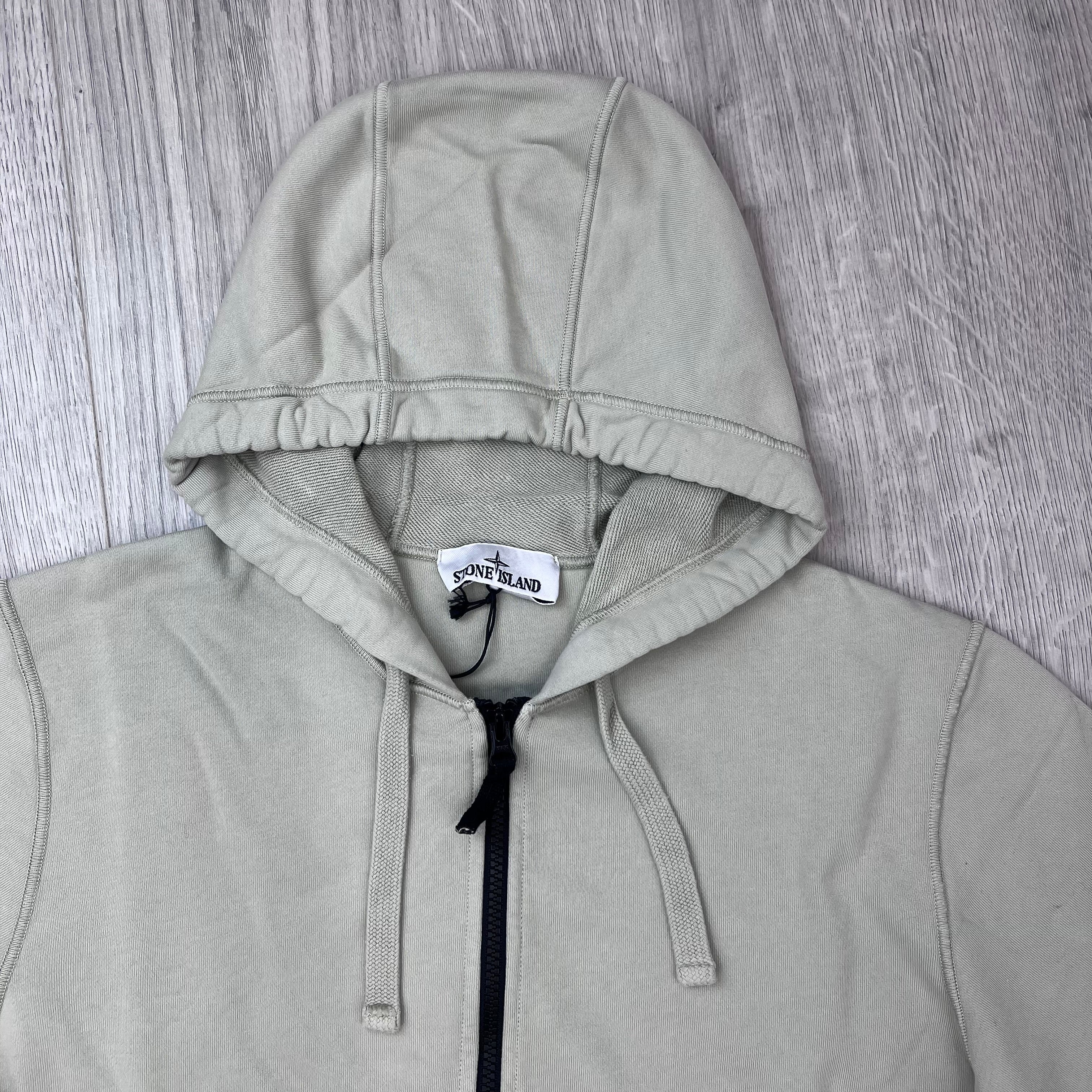 A close up view of the hood and drawstring on the Stone Island Zip Hoodie in Sand. 