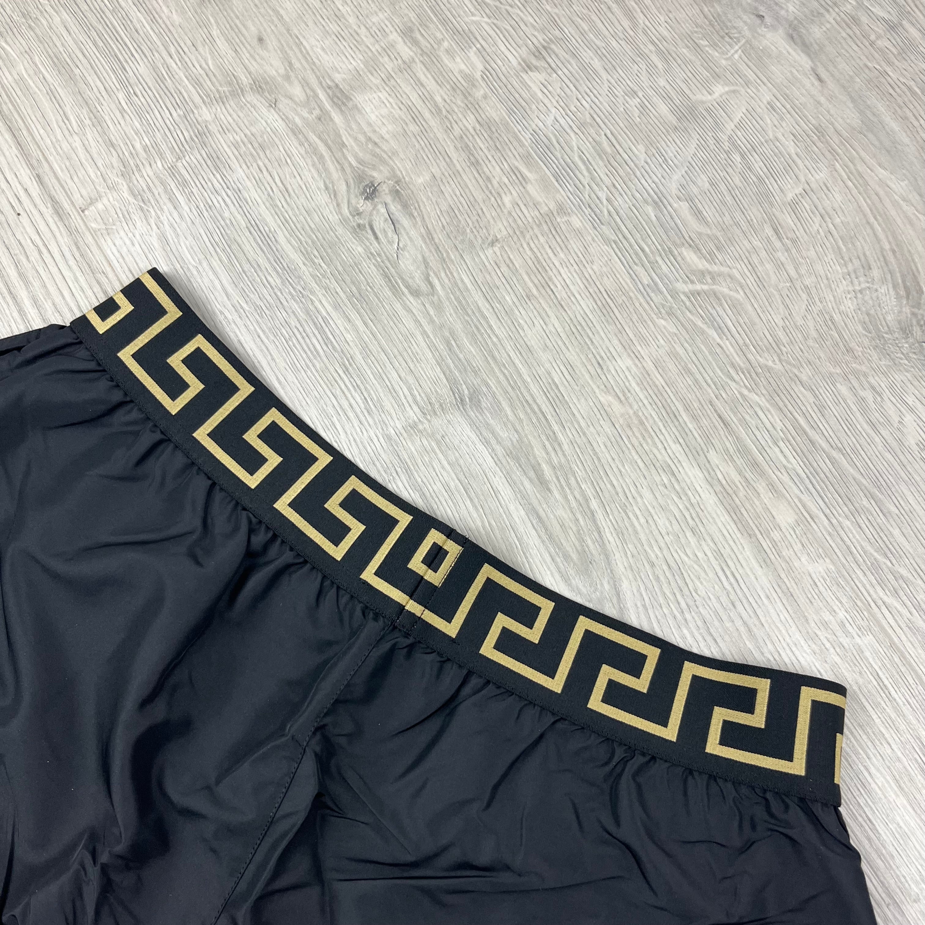 Versace Greca Swim Shorts in Black. On sale at Open Attire.